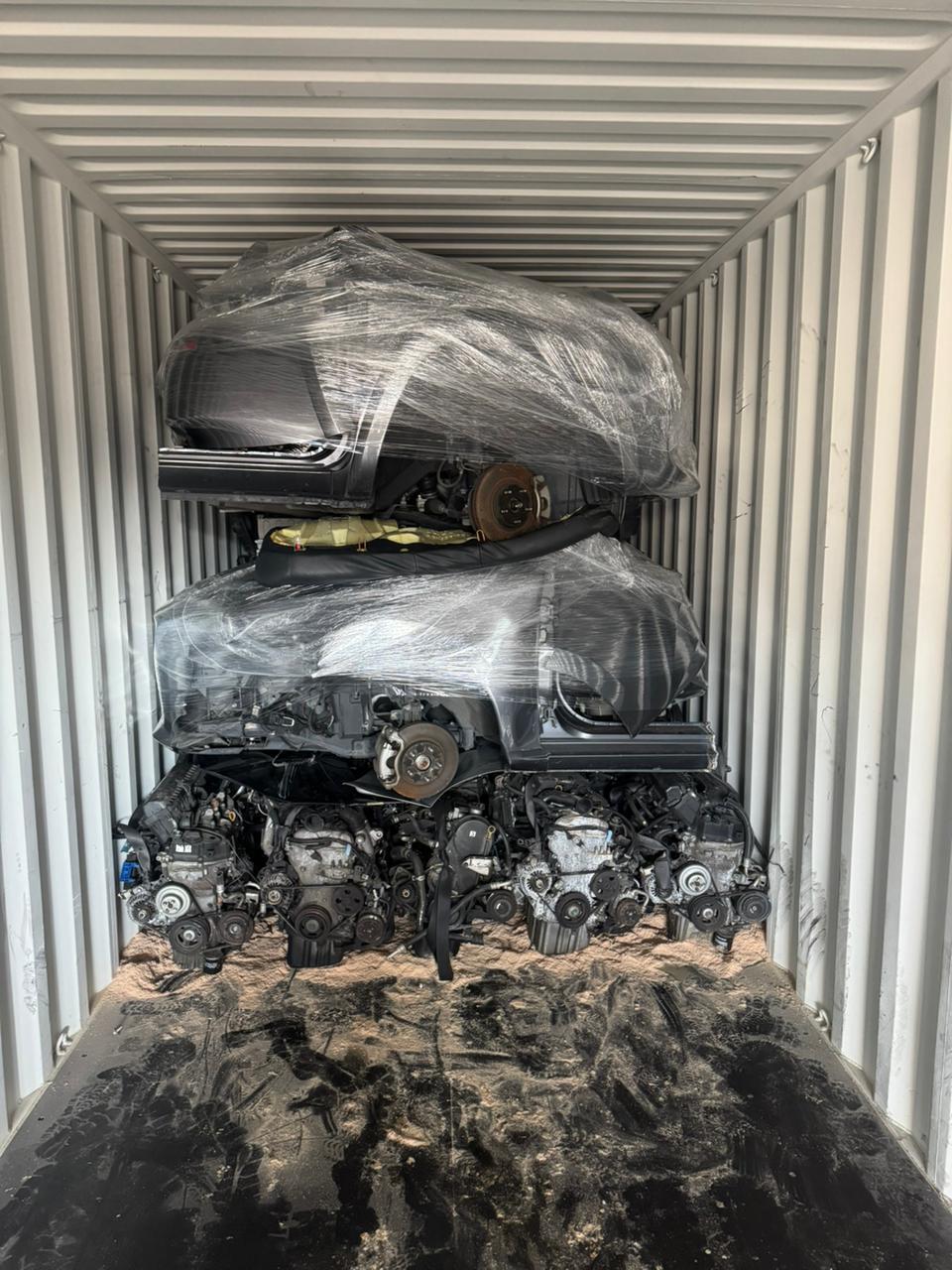 Wrapped half-cut bodies layered over engine row